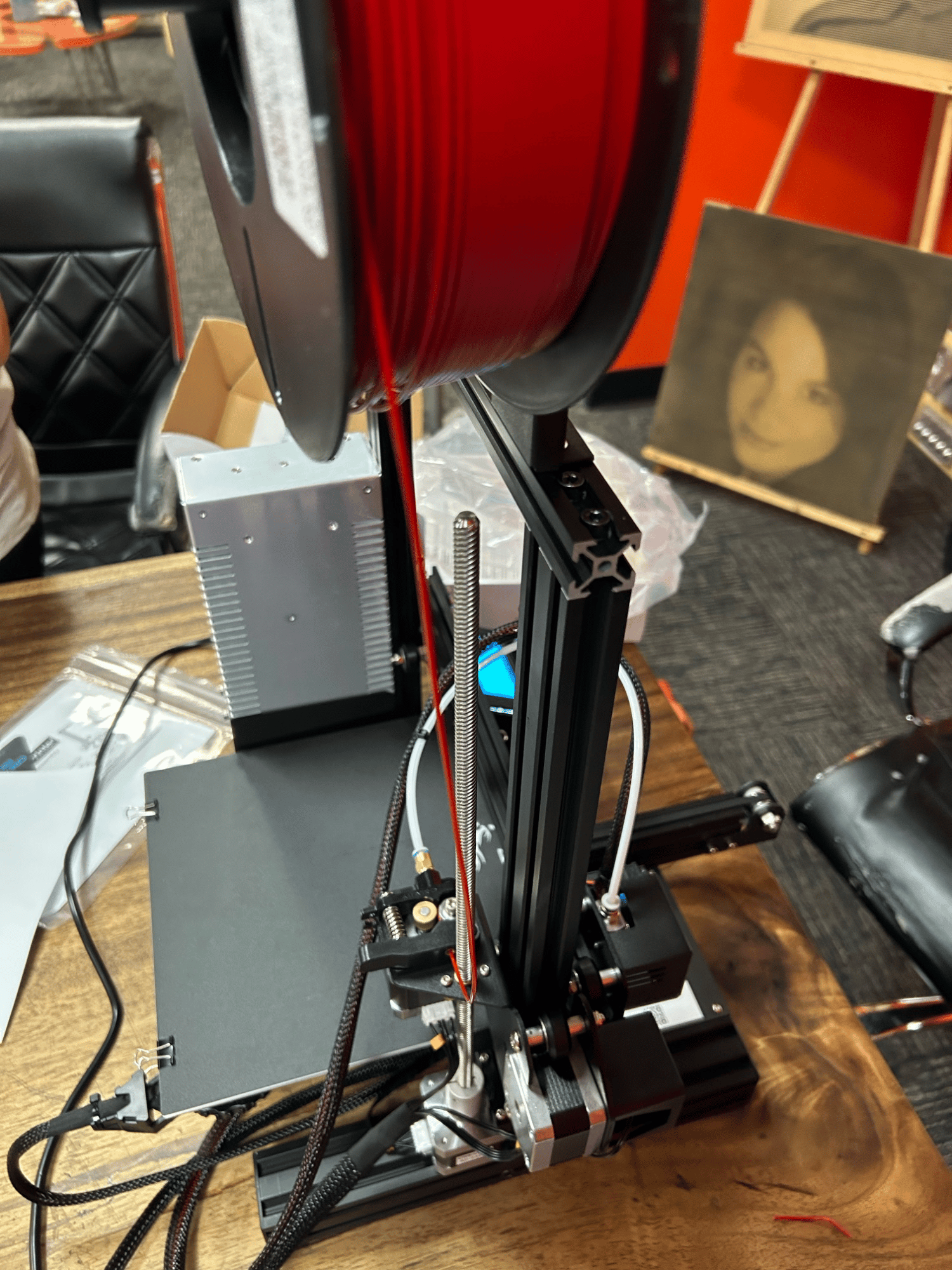 Fig. 3 · The filament path traced from spool to hot end alongside the wiring that drives the extruder and X-axis motors.