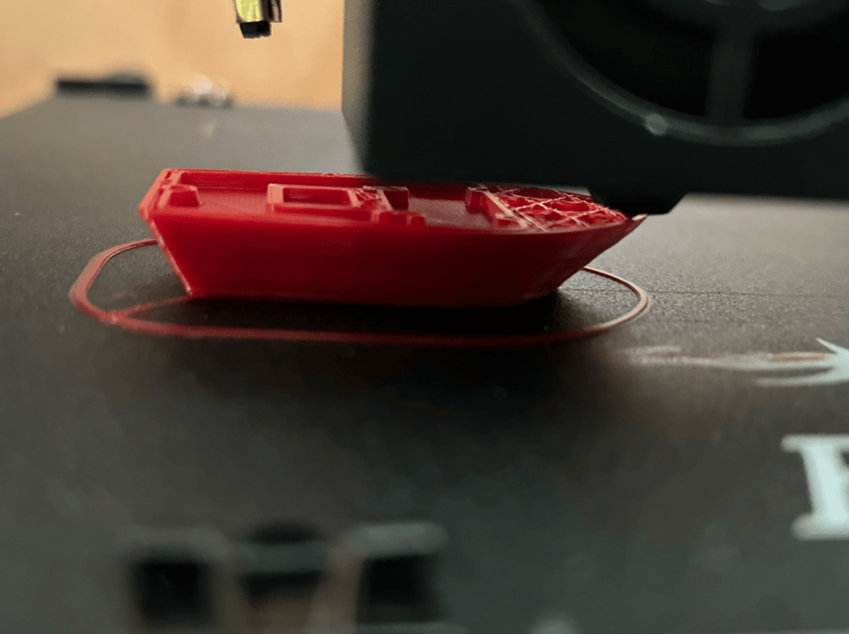 Fig. 5 · A modeled and sliced part printed on the finished machine, closing the loop from digital model to physical part.
