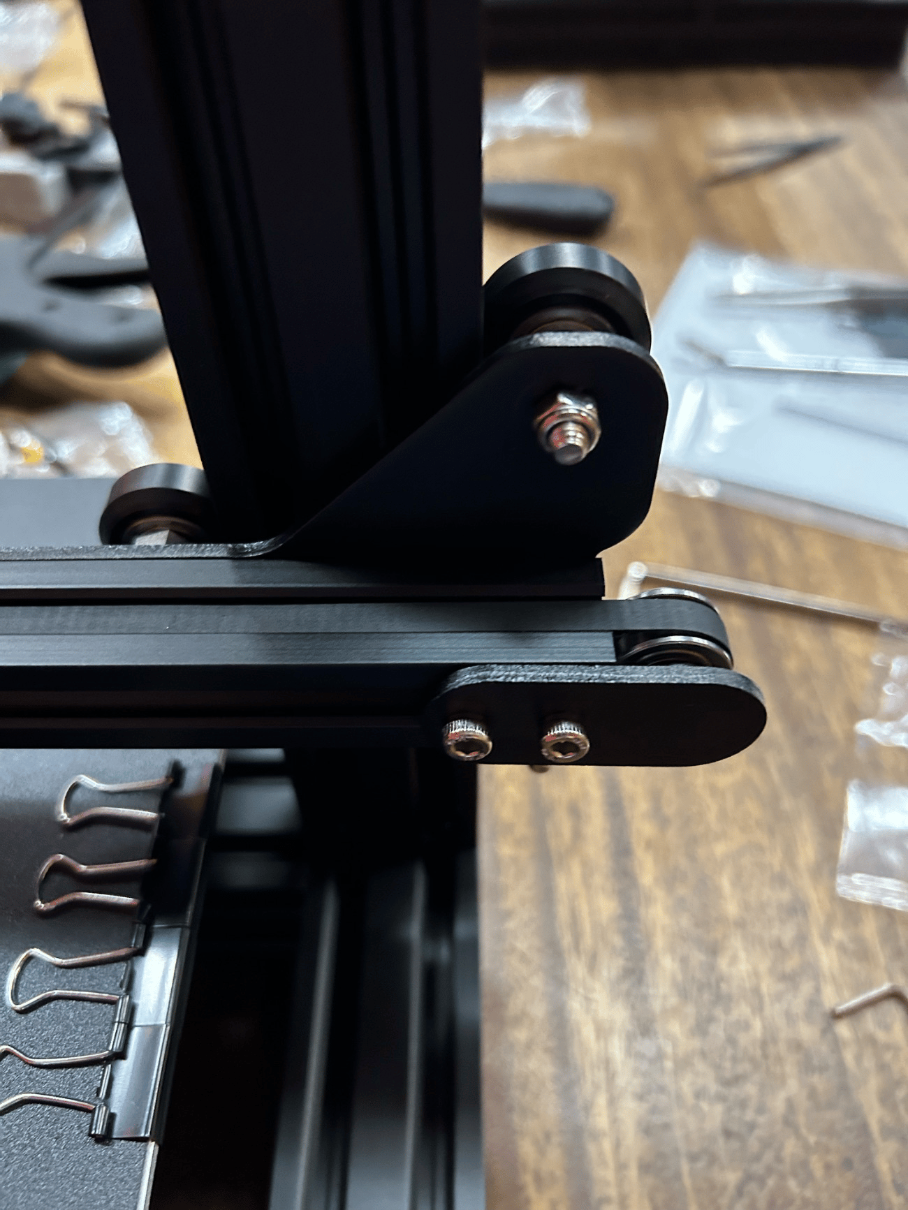 Fig. 2 · The belt-and-V-roller carriage on the X axis: frame squareness and belt tension govern how faithfully it tracks commanded moves.