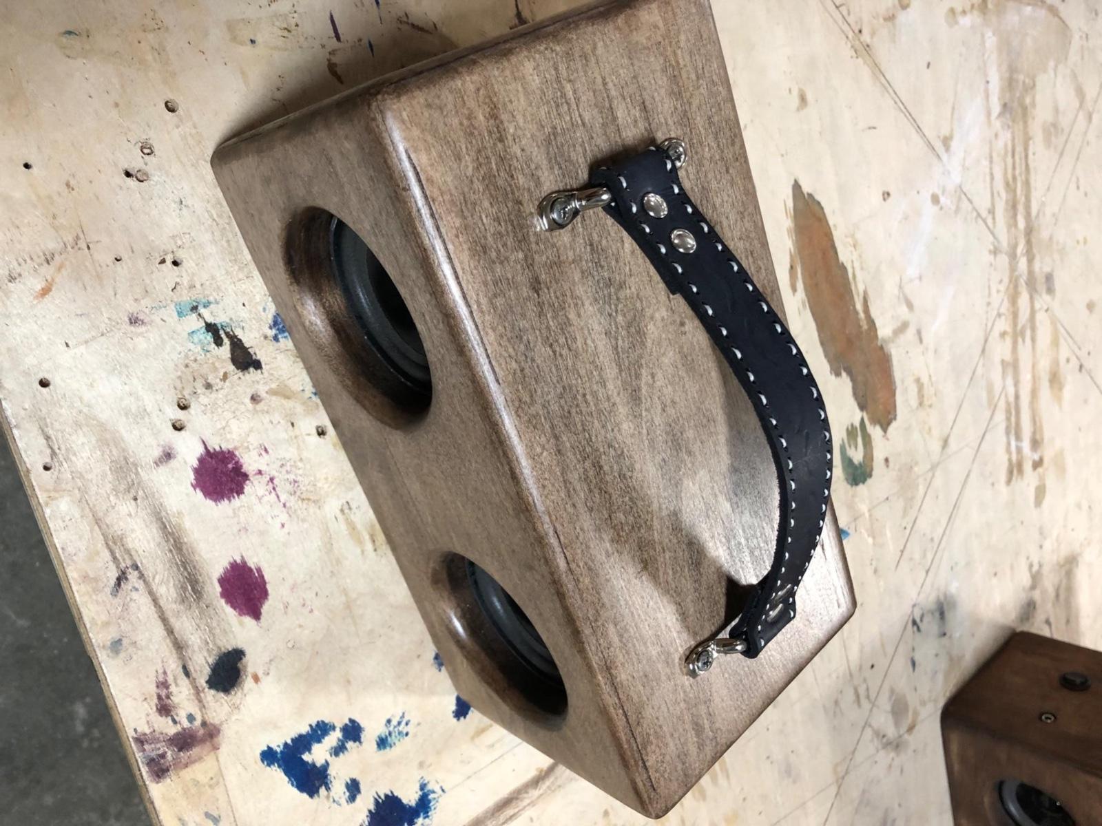 Fig. 1 · The finished product: a mitered hardwood enclosure with twin drivers and a hand-stitched leather handle.