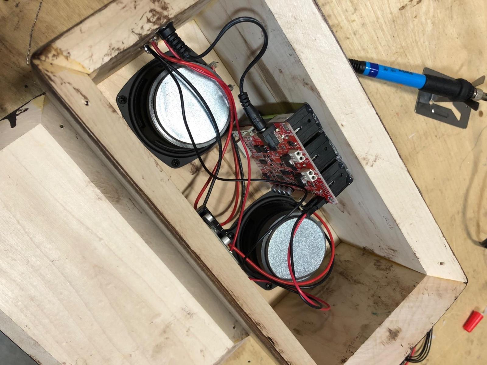 Fig. 4 · Drivers, amplifier board, and battery wired into a single audio chain and bonded inside the cabinet before the rear panel was fastened.