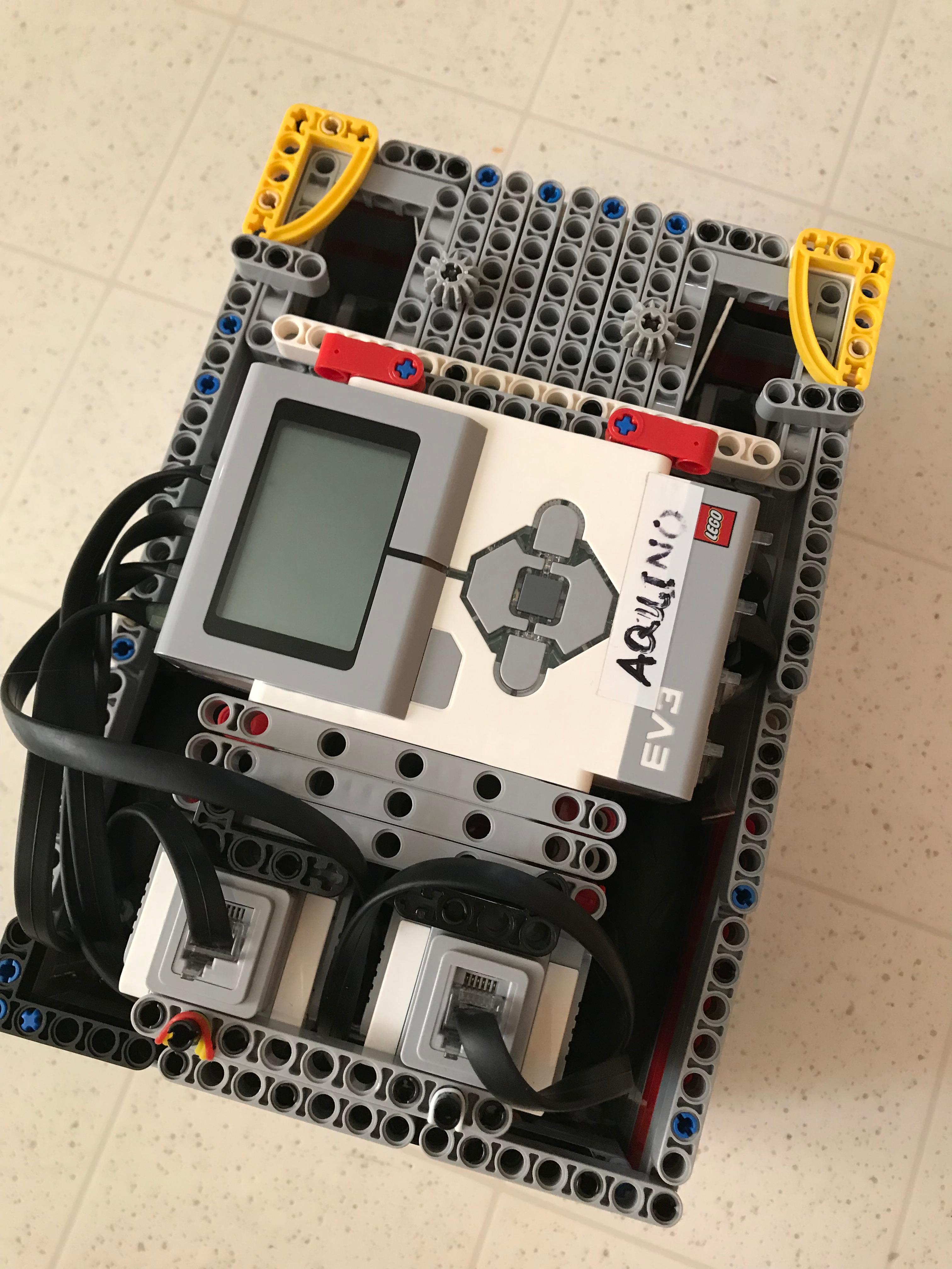 Fig. 1 · The competition robot, top-down: the closed cube faces give fixed, repeatable mounting points for fast attachment swaps.